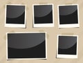 Collection of black old instant photos with frame are sticked on striped brown surface