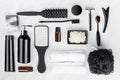 Collection of black and silver luxury glossy cosmetic and accessories for bathing, skin and body care on white wood board.