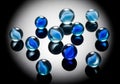 A collection of blue glass marbles, each adorned with a swirling Royalty Free Stock Photo