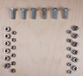 Collection of Bolts and nuts with copy space for your own text on wooden background Royalty Free Stock Photo