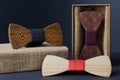 Collection of bow ties made of handmade wood, on a black background