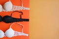 Collection of bras of beige, black and white color on orange background Royalty Free Stock Photo