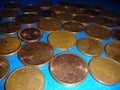 A collection of bronze eurocents on a blue background. Royalty Free Stock Photo