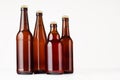 Collection brown beer bottles, mockup. Template for advertising, design, branding identity on white wood table. Royalty Free Stock Photo