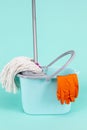 Collection of Bucket, Mop and Cleaning Supplies On Turquoise Background Indoors Royalty Free Stock Photo