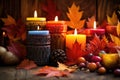 collection of candles and vivid autumn leaves
