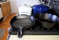 Collection of cast iron cookware on the stove top Royalty Free Stock Photo