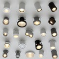 A collection of ceiling-mounted recessed lights of various designs and colors, Royalty Free Stock Photo