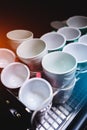 set of ceramic colored cups or mugs heating on professional coffee machine Royalty Free Stock Photo