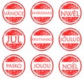 Set of Red Christmas labels in different languages, isolated. Royalty Free Stock Photo