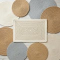 Collection of circular and rectangular woven mats displayed on a Royalty Free Stock Photo