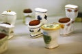 Collection of classic ceramic toilet bowls with wooden seat covers, souvenirs on display