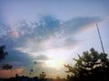 a collection of clouds in the afternoon in an orange and blue sky