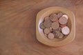 Collection coins copper pence savings in wooden bowl