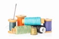 Collection of color thread spools with needle and thimble isolated on white background. Sewing concept Royalty Free Stock Photo