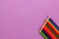 Collection of colored pencils on a purple background top view and copy space. Education, Back to school. Concept Royalty Free Stock Photo