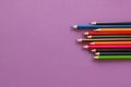 Collection of colored pencils on a purple background top view and copy space. Education, Back to school. Concept Royalty Free Stock Photo