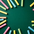 Colorful pieces of chalk on a green school blackboard background with copy space Royalty Free Stock Photo