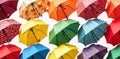 A collection of colorful, folded umbrellas neatly arranged in a minimalist display. A minimalist studio shot of a neat, orderly Royalty Free Stock Photo