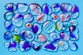 Collection of colorful glass beads of different sizes and shapes. Colored Venetian, Murano glass, millefiori. On a blue background Royalty Free Stock Photo