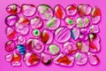 Collection of colorful glass beads of different sizes and shapes. Colored Venetian, Murano glass, millefiori. On a Pink fuchsia Royalty Free Stock Photo