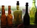 Collection of colorful glass bottles in a window Royalty Free Stock Photo