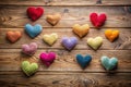 A collection of colorful handmade crocheted hearts arranged on a rustic wooden surface, a delightful display of affection and Royalty Free Stock Photo