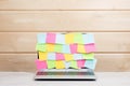 Collection of colorful sticky memos on a laptop