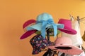 Collection of colorful summer hats hanged on a hat rack against bright orange background Royalty Free Stock Photo