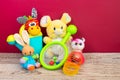 Collection of colorful toys on burgundy background. Kids toys