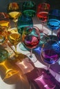 Collection of colorful wine glasses casting vibrant shadows Royalty Free Stock Photo