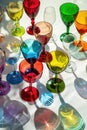 Collection of colorful wine glasses casting vibrant shadows Royalty Free Stock Photo