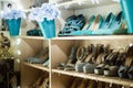 Collection of colourful shoes on shelves in interior.