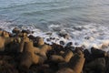 A collection of concrete breakwater on the beach during the day in Cilacap Indonesia