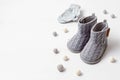 Collection of cute organic baby clothes and booties. Warm gender neutral outfit for cold weather Royalty Free Stock Photo