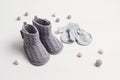 Collection of cute organic baby clothes and booties. Warm gender neutral outfit for cold weather Royalty Free Stock Photo