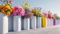 A collection of cylindrical vases filled with vibrant flowers positioned in a linear formation Royalty Free Stock Photo