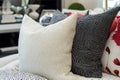 A collection of decorative pillows on a sofa. The foremost pillow is white with a Royalty Free Stock Photo
