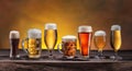 Collection of different beer glasses and beer types on old wooden table Royalty Free Stock Photo