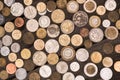 Collection of different coins on wooden tabletop, pile of coins concept