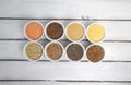 Collection of different groats on grey background. Top view of buckwheat, chia, flax, amaranth, lentils, couscous, wheat