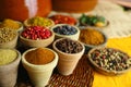 Collection of different spices in old clay bowls in colorful oriental style