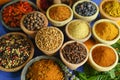 Collection of different spices in old clay bowls in colorful oriental style