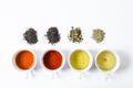 Collection of different teas in cups with tea leaves on a white background Royalty Free Stock Photo