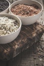 Collection of different varieties of rice on wooden rustic background Royalty Free Stock Photo