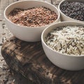 Collection of different varieties of rice on wooden rustic background Royalty Free Stock Photo