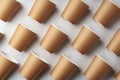 A collection of disposable paper cups arranged in a repeating pattern on a light background Royalty Free Stock Photo
