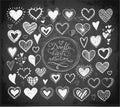 Collection of doodle sketch hearts hand drawn with ink on blackboard background. Royalty Free Stock Photo