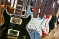 A collection of electric solid body guitars hanging in a row Royalty Free Stock Photo