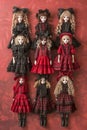 Collection of Elegant Goth Lolita Style Dolls in Black and Red Dresses Arranged Artfully on Red Background